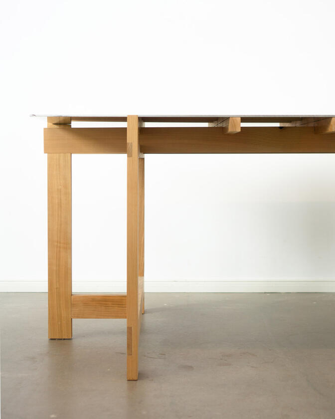 a desk made of solid european cherry wood with a surface of handbrushed aluminium designed by Liam Barwick