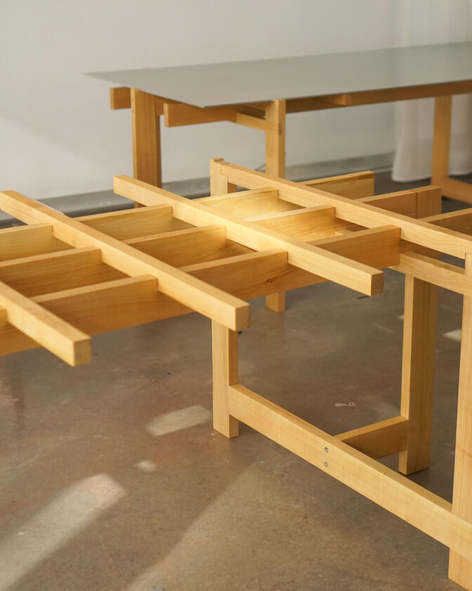 a desk made of solid european cherry wood with a surface of handbrushed aluminium designed by Liam Barwick