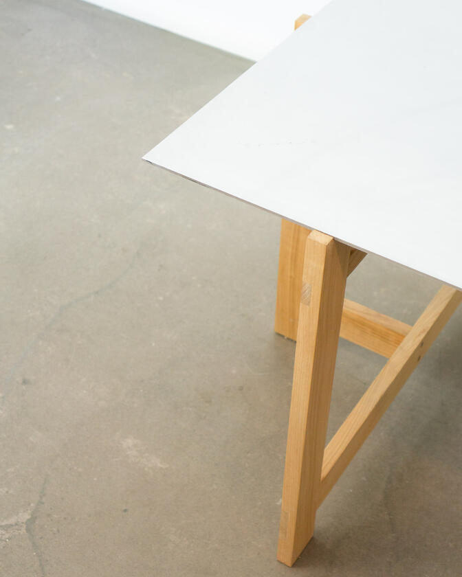 a desk made of solid european cherry wood with a surface of handbrushed aluminium designed by Liam Barwick