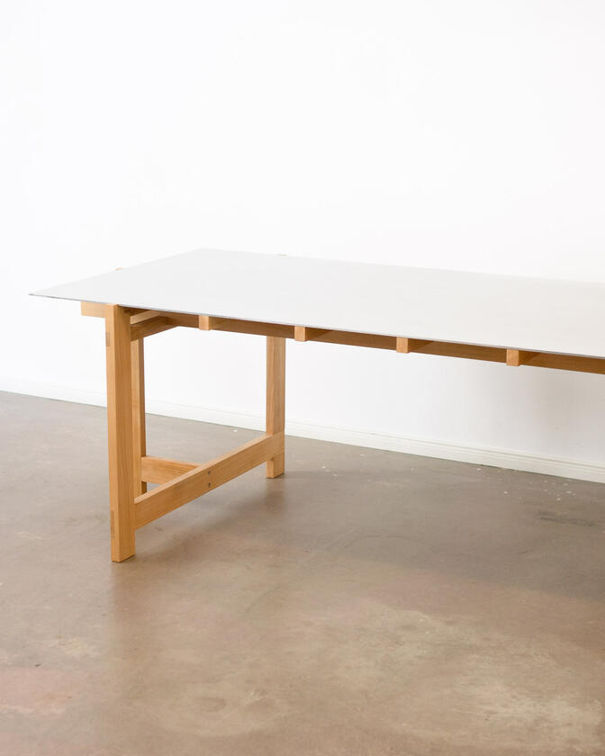 a desk made of solid european cherry wood with a surface of handbrushed aluminium designed by Liam Barwick