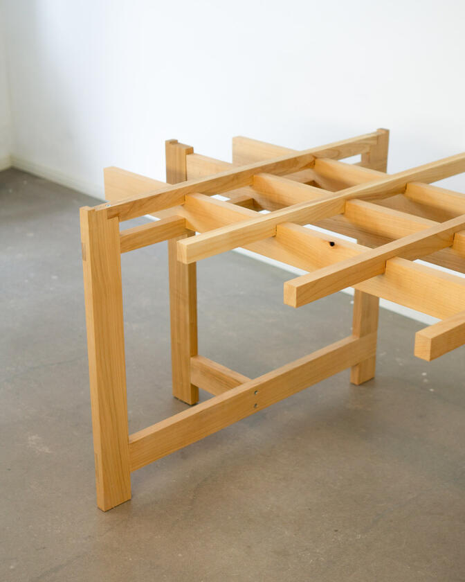 a desk made of solid european cherry wood with a surface of handbrushed aluminium designed by Liam Barwick