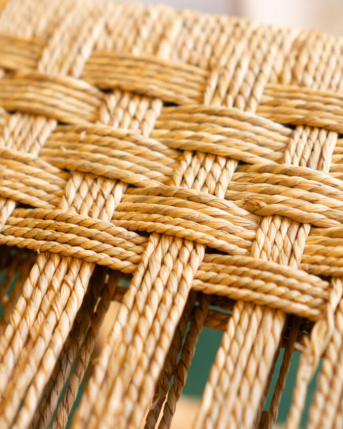 A stool made of solid european cherry wood and a handwoven seat of braided seagrass designed and made by Liam Barwick