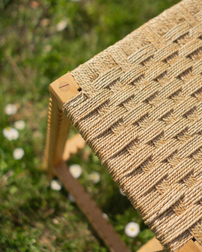 A stool made of solid european cherry wood and a handwoven seat of braided seagrass designed and made by Liam Barwick