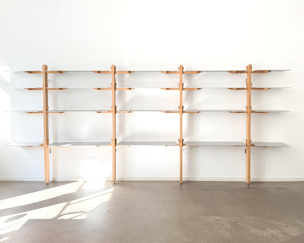 Wall shelf constructed of solid european cherry and hand brushed aluminium shelving designed and made by Liam Barwick