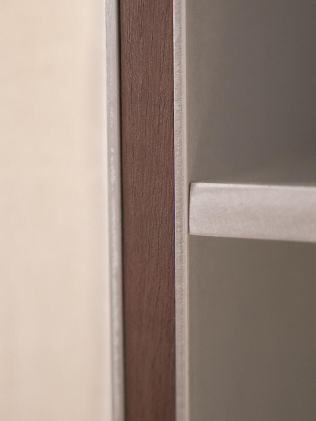 A wall lamp made of hand brushed aluminium with a strip of dark hardwood and a soft calico cover. Designed and made by Liam Barwick