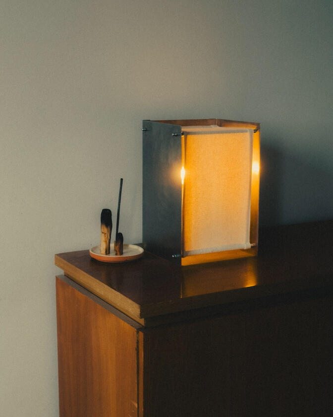 A table lamp constructed of a raw steel exterior and a soft organic cotton canvas diffuser. Designed and constructed by Liam Barwick