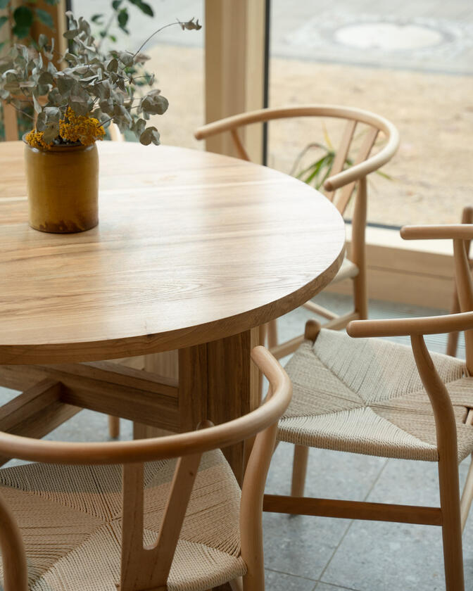 A large wooden round table 120cm in diameter made of solid ash wood. Designed and made by Liam Barwick