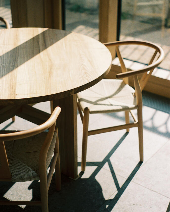 A large wooden round table 120cm in diameter made of solid ash wood. Designed and made by Liam Barwick
