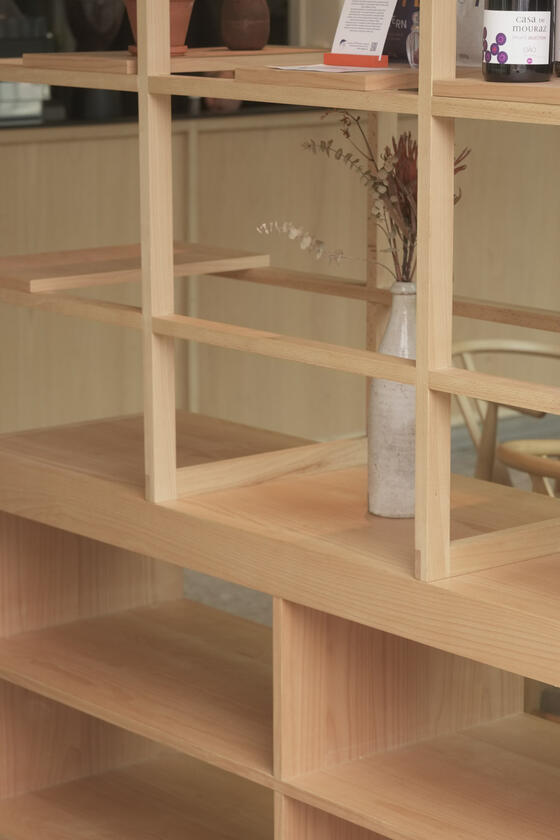 A shelving unit and room divider made of beech wood designer and built by Liam Barwick
